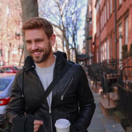 Nick Viall in a black leather jacket poses for a picture.